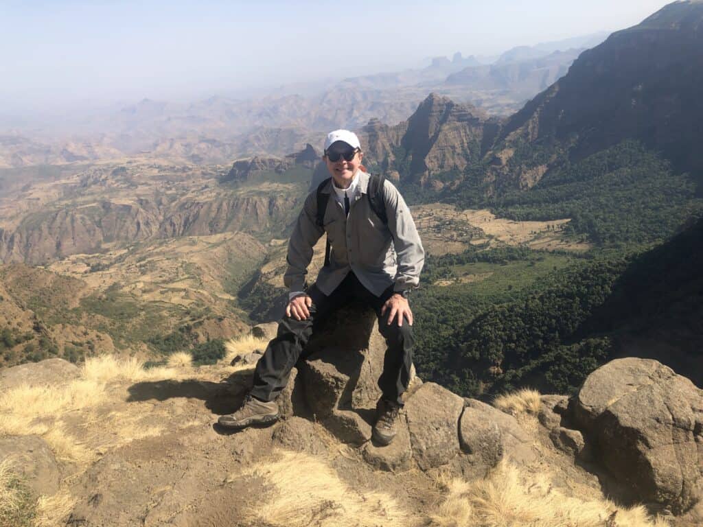 Image of a man at the top of a mountain